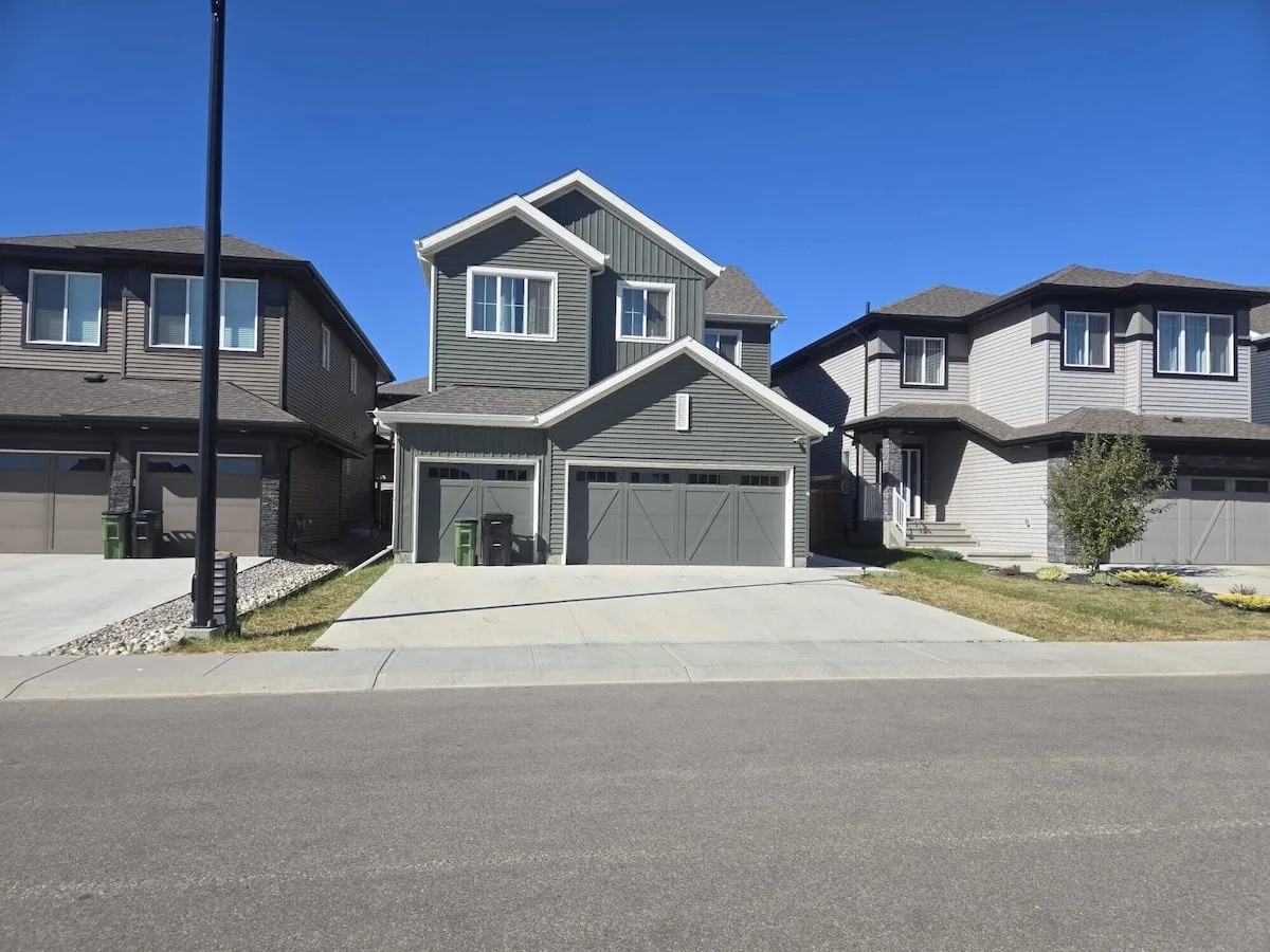 Edgemont furnished main-floor home — front exterior with triple-car garage