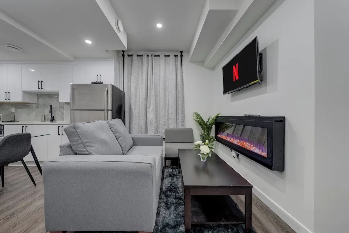 Living room with electric fireplace and wall-mounted smart TV