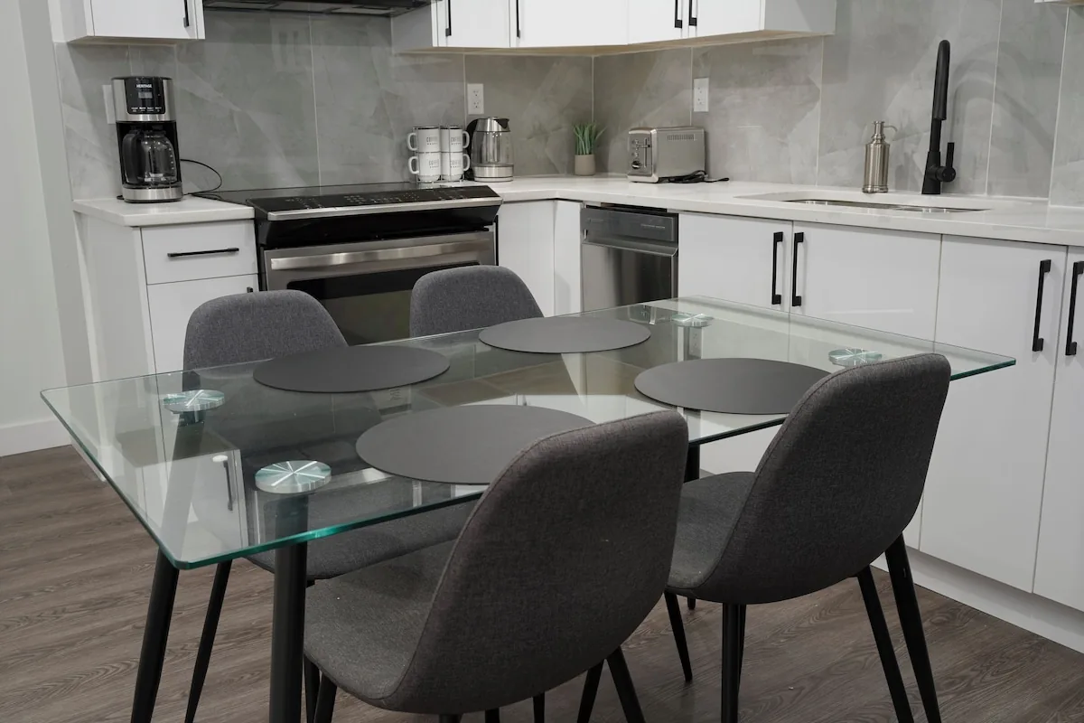 Open-concept kitchen with glass dining table