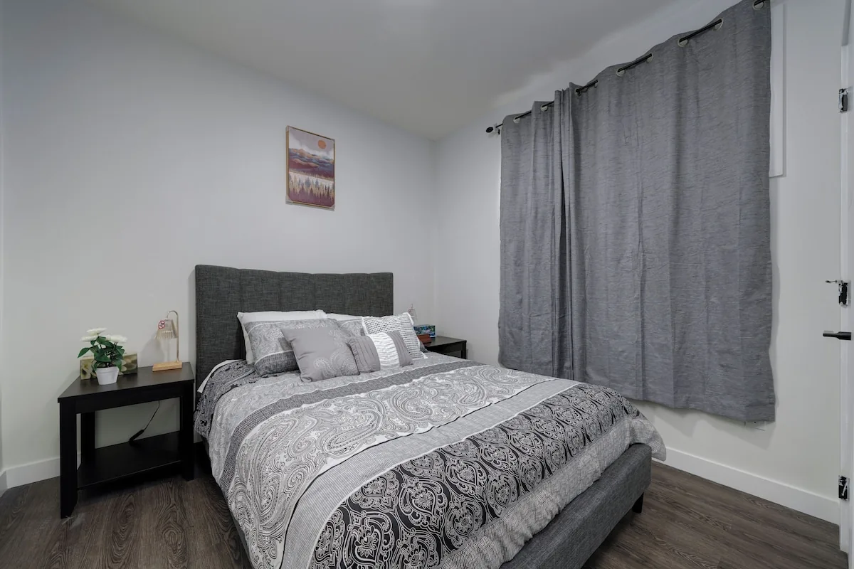 Bedroom with upholstered bed and blackout curtains