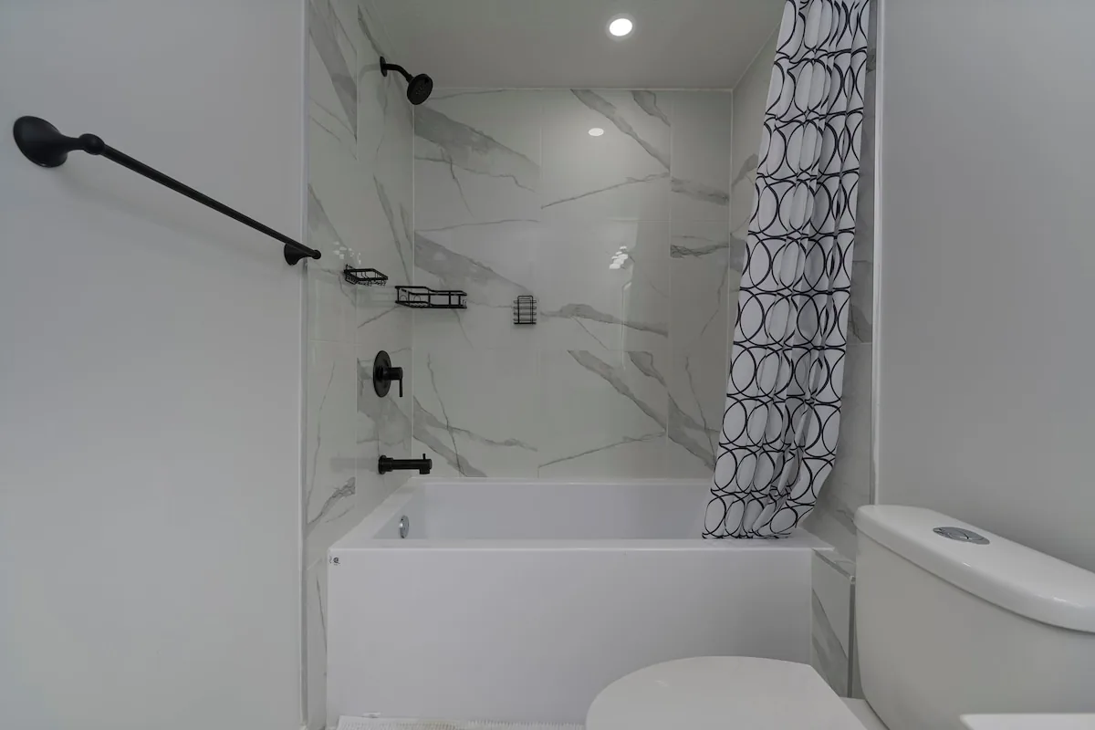 Marble-tiled tub and shower